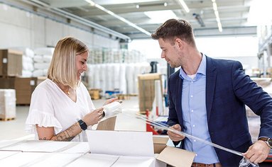 Ein Verpackungsberater berät eine Kundin vor Ort zu Stretchfolie. 