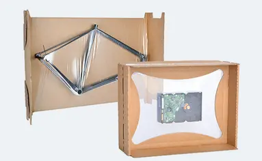 Bild zeigt einen Fahrrad-Rahmen in einer Fixierverpackung und eine Festplatte in einer Membranverpackung.