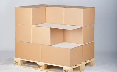 Auf einer Holzpalette stapeln Kartons, die mit Zuschnitten unterteilt wurden.