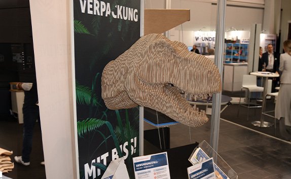 Ein geplotteter Dinokopf auf dem Messestand von PRODINGER auf der EMPACK 2026 in Dortmund